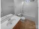 Clean bathroom with a single sink vanity, toilet, and bathtub with shower, offering a practical space at 6318 Pink Dogwood Ln, Charlotte, NC 28262