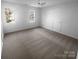 Large bedroom featuring neutral carpet, white walls, a ceiling fan, and natural light from two windows at 6318 Pink Dogwood Ln, Charlotte, NC 28262