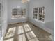 Dining area featuring large windows and vinyl flooring, providing ample natural light and a cozy atmosphere at 6318 Pink Dogwood Ln, Charlotte, NC 28262