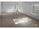 Spacious room bathed in natural light, featuring neutral carpeting and multiple windows at 6318 Pink Dogwood Ln, Charlotte, NC 28262