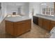 Eat-in kitchen features a center island, light-colored cabinetry, and an open layout to the living area at 6318 Pink Dogwood Ln, Charlotte, NC 28262