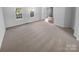 Bright living room featuring neutral carpet, white walls, and two large windows that illuminate the space at 6318 Pink Dogwood Ln, Charlotte, NC 28262