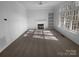 Neutral living room with a fireplace, large windows, and built-in shelves, bathed in natural light at 6318 Pink Dogwood Ln, Charlotte, NC 28262