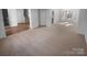 Spacious living area with a mix of hardwood and carpet, bathed in natural light from multiple windows at 6318 Pink Dogwood Ln, Charlotte, NC 28262
