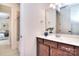 Bathroom featuring a vanity with dark wood cabinets and a large mirror at 6521 Shoff Cir, Charlotte, NC 28215