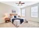Cozy bedroom with a ceiling fan, natural light, and tasteful decor at 6521 Shoff Cir, Charlotte, NC 28215