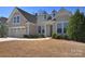 Charming single-Gathering home featuring a two-car garage, dormer windows, and a well-manicured lawn at 6521 Shoff Cir, Charlotte, NC 28215