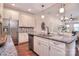 Modern kitchen featuring stainless steel appliances, granite countertops, and a stylish backsplash at 6521 Shoff Cir, Charlotte, NC 28215