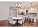 Charming breakfast nook off kitchen with seating for four, modern lighting, and hardwood floors at 6521 Shoff Cir, Charlotte, NC 28215