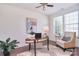 Inviting home office with a ceiling fan, natural light, and modern decor at 6521 Shoff Cir, Charlotte, NC 28215