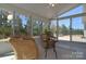Bright sunroom with multiple windows providing lots of natural light, and comfortable wicker furniture at 6521 Shoff Cir, Charlotte, NC 28215