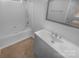 Clean bathroom featuring a tub-shower and a gray vanity at 6809 Brancusi Ct, Charlotte, NC 28215