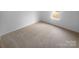 Bedroom with neutral carpet and large window offers a cozy and inviting space at 6809 Brancusi Ct, Charlotte, NC 28215