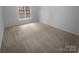 Cozy carpeted bedroom offers a sunny window that brings in natural light at 6809 Brancusi Ct, Charlotte, NC 28215