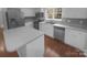 A modern kitchen featuring stainless steel appliances, wood flooring, and sleek countertops at 6809 Brancusi Ct, Charlotte, NC 28215