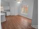 Bright living area features hardwood floors, a ceiling fan, and a large window providing plenty of natural light at 6809 Brancusi Ct, Charlotte, NC 28215