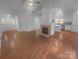 Expansive living area featuring a fireplace, hardwood flooring, and an open layout at 6809 Brancusi Ct, Charlotte, NC 28215