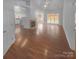 Spacious living room with hardwood floors, a fireplace, and natural light from large windows at 6809 Brancusi Ct, Charlotte, NC 28215