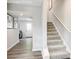 Spacious hallway featuring hardwood floors and a staircase leading to the upper level at 7132 Capstan Ter # B, Charlotte, NC 28269