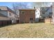 A spacious backyard with a brick house featuring symmetrical windows and a well-maintained lawn at 732 Ellsworth Rd, Charlotte, NC 28211
