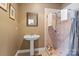 Bathroom featuring a pedestal sink and shower at 732 Ellsworth Rd, Charlotte, NC 28211
