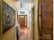 Hallway with wood floors, high ceilings, artwork, and a view of the front door at 732 Ellsworth Rd, Charlotte, NC 28211