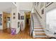 Hallway features hardwood floors, staircase, and decorated walls at 732 Ellsworth Rd, Charlotte, NC 28211