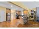 Well-lit kitchen featuring a kitchen island, modern appliances, and hardwood flooring at 732 Ellsworth Rd, Charlotte, NC 28211