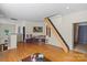 Cozy living room featuring hardwood floors, natural light, and unique staircase to an attic at 732 Ellsworth Rd, Charlotte, NC 28211