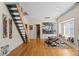 Living room featuring hardwood floors, natural light, staircase, and contemporary design at 732 Ellsworth Rd, Charlotte, NC 28211