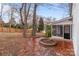 Backyard featuring brick patio, fire pit, and mature trees at 805 East St, Albemarle, NC 28001