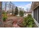 Backyard featuring brick patio, privacy fence, and mature trees at 805 East St, Albemarle, NC 28001