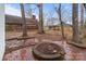 Backyard featuring brick patio, fire pit, and mature trees at 805 East St, Albemarle, NC 28001