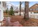 Backyard featuring a wrought iron fence and a brick-paved area, perfect for entertaining at 805 East St, Albemarle, NC 28001