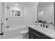 Updated bathroom featuring a subway-tiled shower, stylish vanity with black fixtures, and marble floors at 805 East St, Albemarle, NC 28001