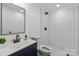 Modern bathroom with subway tile shower, sleek vanity, and contemporary fixtures at 805 East St, Albemarle, NC 28001