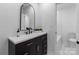 Elegant bathroom vanity with a sleek black cabinet, quartz countertop, and modern black faucet at 805 East St, Albemarle, NC 28001