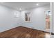 A bedroom shows hardwood floors and classic windows with custom iron work at 805 East St, Albemarle, NC 28001
