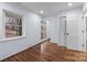 Bedroom features hardwood floors, white trim, and a door to an outdoor area at 805 East St, Albemarle, NC 28001