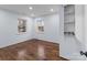 A bedroom with two windows, hardwood floors, and classic white accents at 805 East St, Albemarle, NC 28001