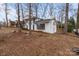 A lovely two-story white house surrounded by mature trees on a spacious lot at 805 East St, Albemarle, NC 28001