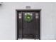 Close up of the front door with a green wreath on a white brick home at 805 East St, Albemarle, NC 28001