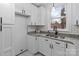 Bright kitchen with white cabinets, stainless steel sink, and granite countertops at 805 East St, Albemarle, NC 28001