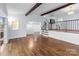 Spacious living room featuring hardwood floors, beams, and access to stairs at 805 East St, Albemarle, NC 28001