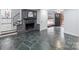Inviting living room with stone flooring, a brick fireplace, and a view of the front entrance at 805 East St, Albemarle, NC 28001