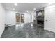Bright living room featuring stone floors, a cozy fireplace, and sliding glass doors at 805 East St, Albemarle, NC 28001