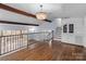 Second-floor living space with hardwood floors, chandelier, and stairs at 805 East St, Albemarle, NC 28001
