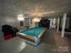 Basement featuring a pool table, neutral paint, and tile flooring at 816 Horah W St, Salisbury, NC 28144
