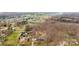 An aerial view shows a home, neighboring properties, outbuildings and a swimming pool surrounded by forest and open land at 822 Bethlehem Rd, Kings Mountain, NC 28086