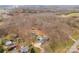 An aerial view reveals a home nestled among trees along with outbuildings, a pool, and a lengthy driveway at 822 Bethlehem Rd, Kings Mountain, NC 28086